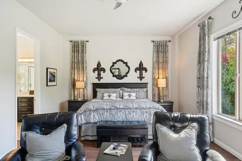 a bedroom with furniture and a large window