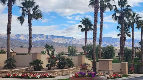 a view of a chairs and table in patio with a lake view