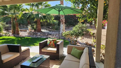 a front view of a house with porch and mountain view