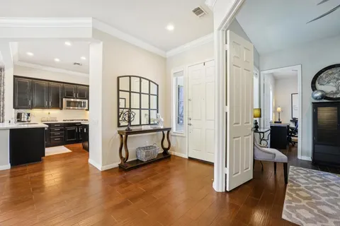 a living room with furniture a flat screen tv and a large window