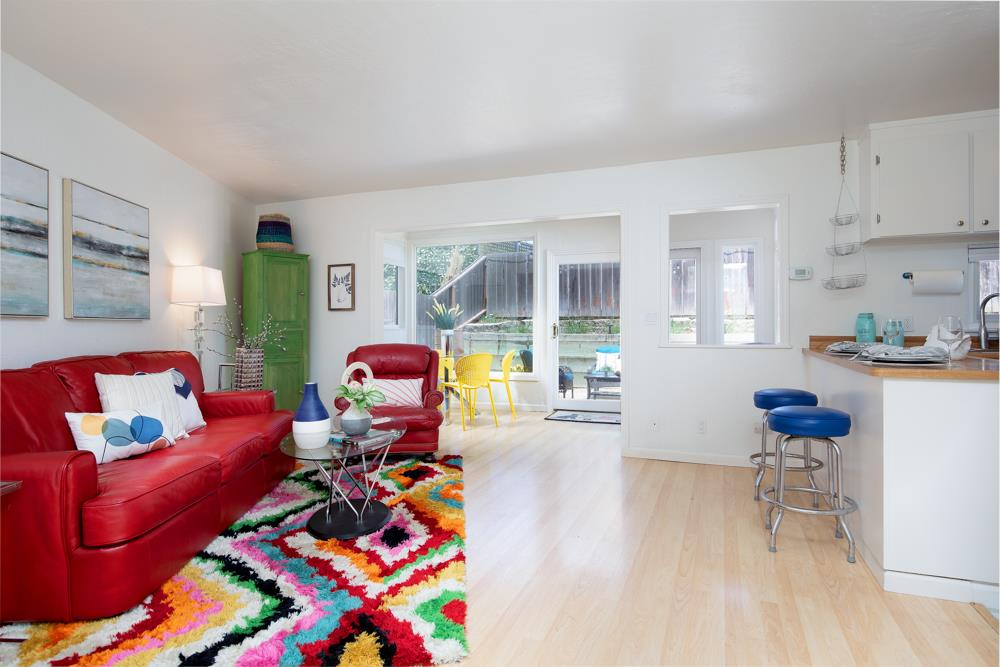 380 Sea Ridge Road, Unit E Aptos, CA 95003 - Photo 12 of 27 a living room with furniture and a dining table with wooden floor