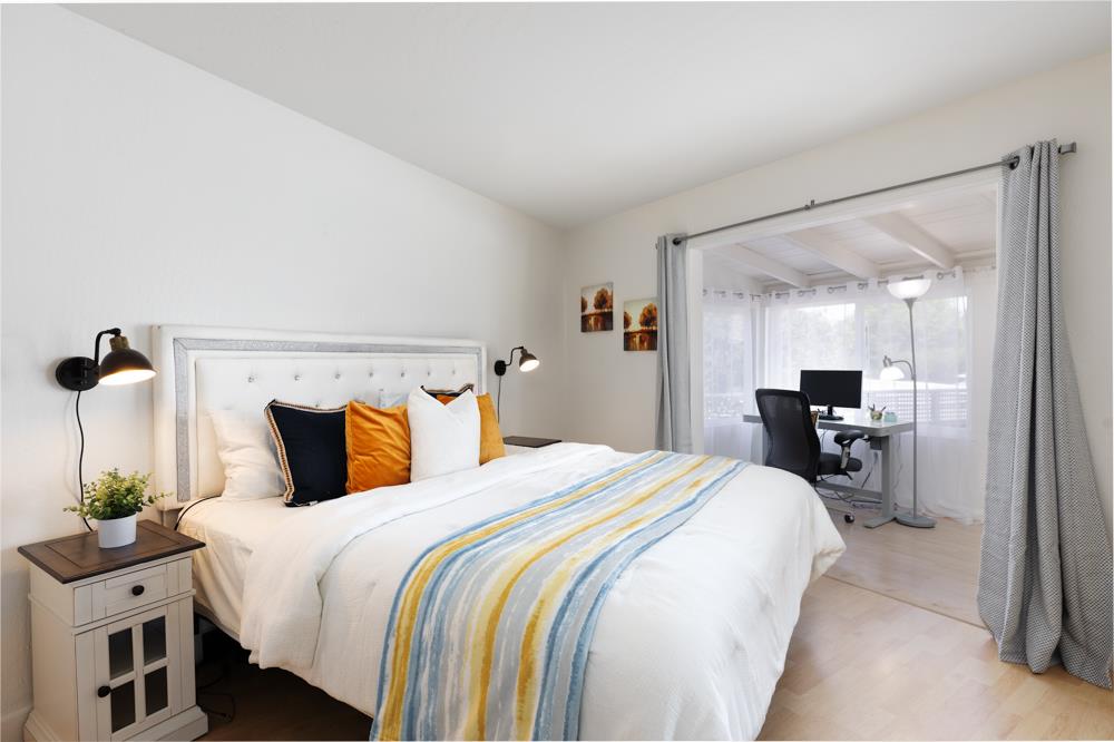 380 Sea Ridge Road, Unit E Aptos, CA 95003 - Photo 19 of 27 a bedroom with a bed and a large mirror