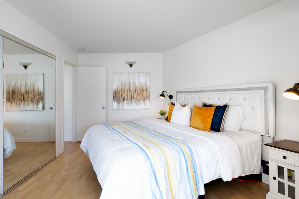 380 Sea Ridge Road, Unit E Aptos, CA 95003 - Photo 21 of 27 a bedroom with a bed and glass walk in closet