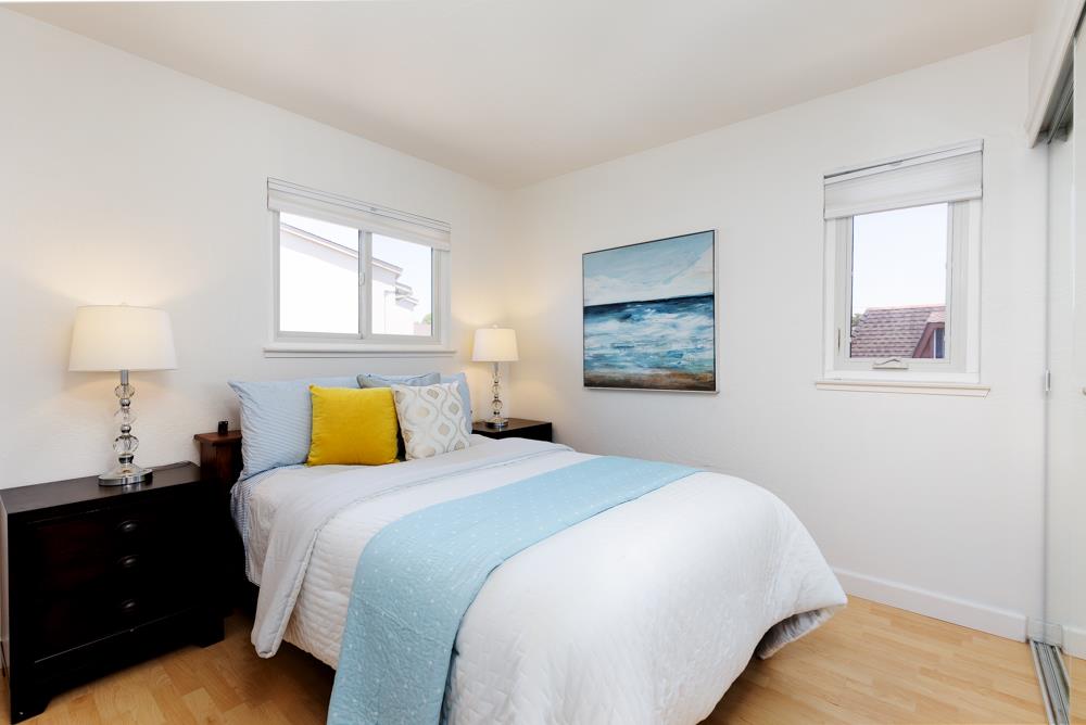 380 Sea Ridge Road, Unit E Aptos, CA 95003 - Photo 24 of 27 a bedroom with a bed and a window