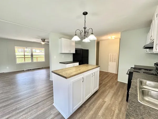 a kitchen with sink stove and refrigerator