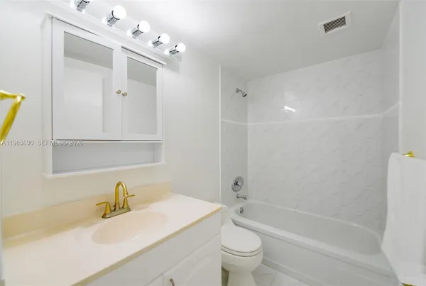 a view of a tall building next to a road