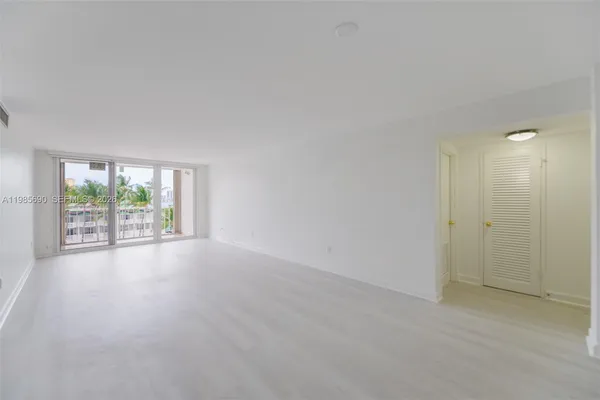 a kitchen with a sink a refrigerator and cabinets