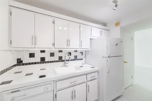 a kitchen that has a sink and a stove