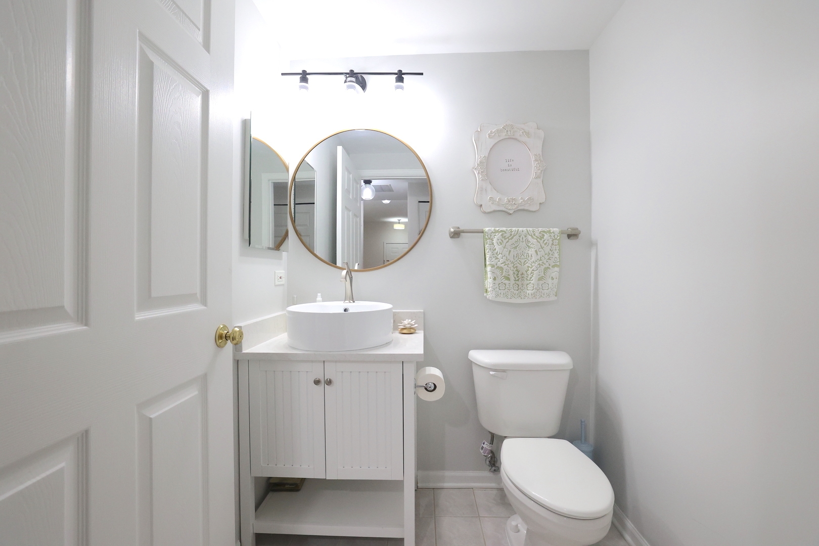 650 Mill Circle, Unit 103 Wheeling, IL 60090 - Photo 14 of 14 a bathroom with a toilet a sink and mirror