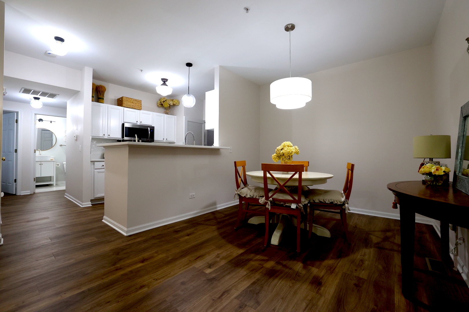 650 Mill Circle, Unit 103 Wheeling, IL 60090 - Photo 3 of 14 a kitchen with stainless steel appliances a table chairs and a refrigerator