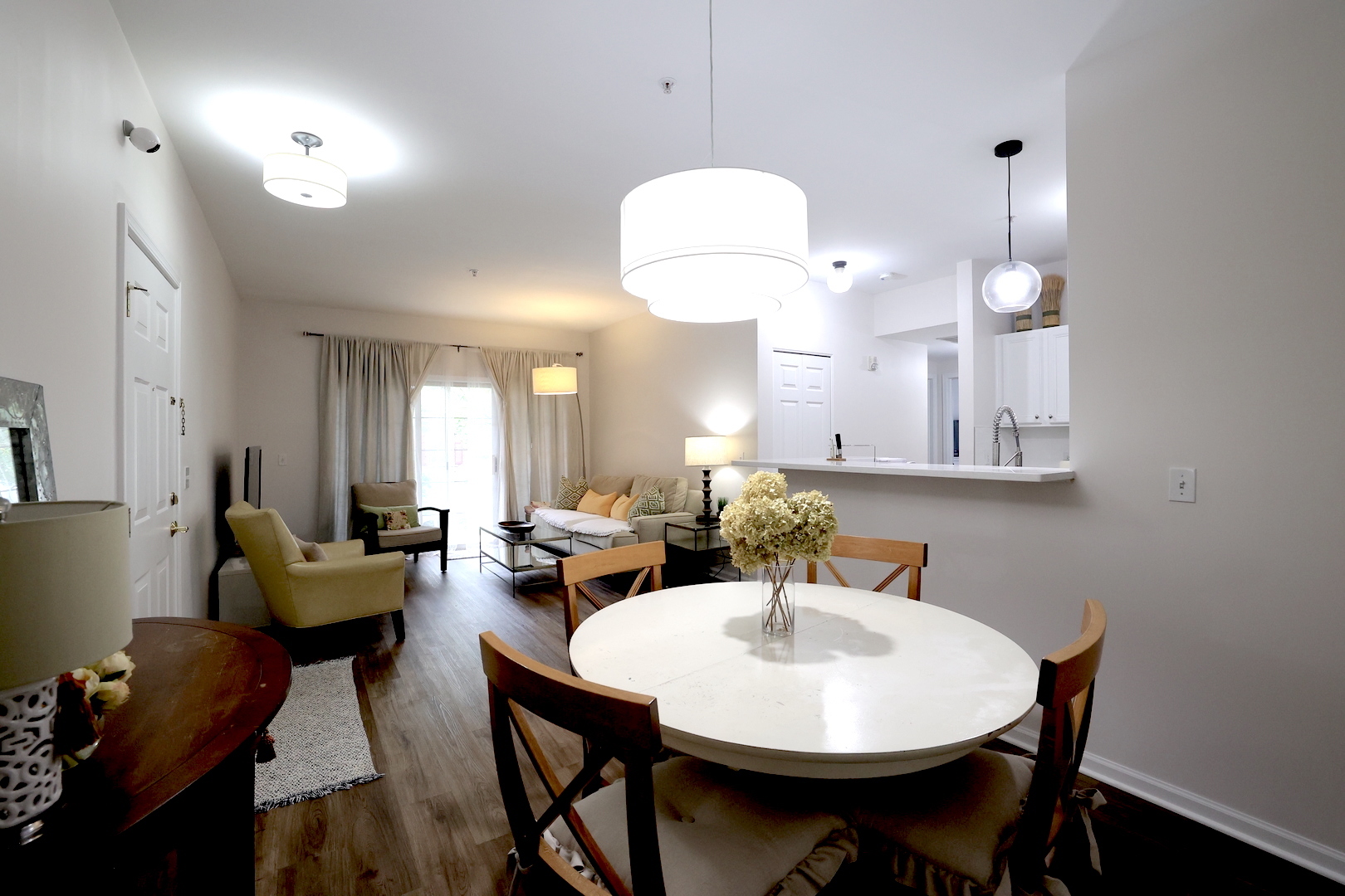 650 Mill Circle, Unit 103 Wheeling, IL 60090 - Photo 4 of 14 a view of a dining room with furniture and wooden floor