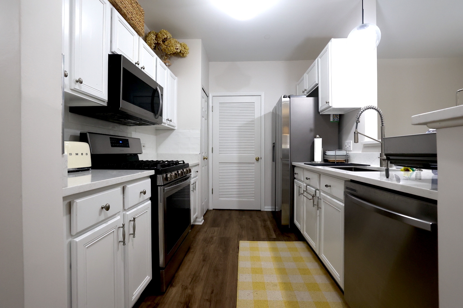 650 Mill Circle, Unit 103 Wheeling, IL 60090 - Photo 5 of 14 a kitchen with stainless steel appliances granite countertop a refrigerator sink and microwave