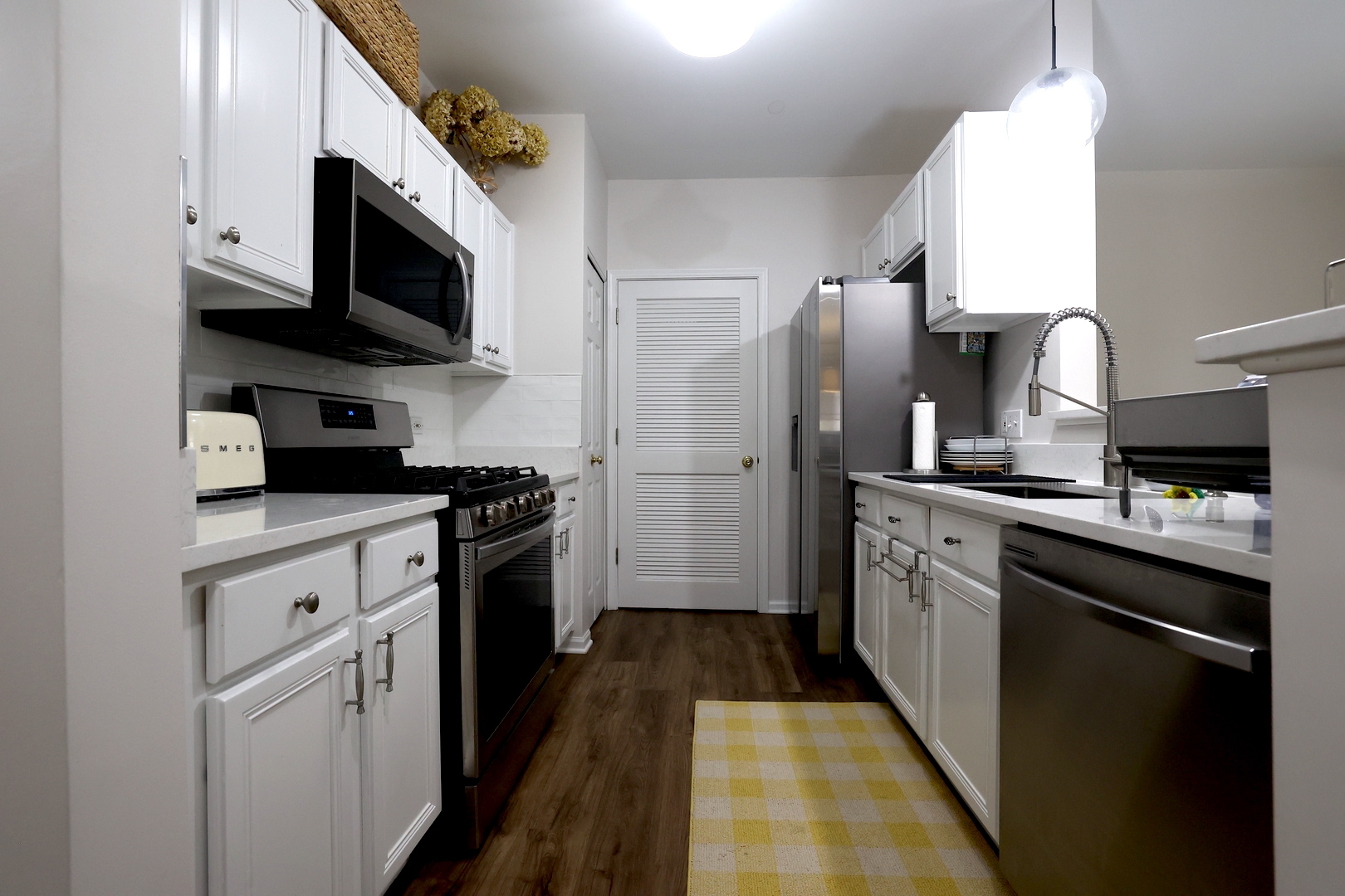 650 Mill Circle, Unit 103 Wheeling, IL 60090 - Photo 6 of 14 a kitchen with stainless steel appliances granite countertop a refrigerator sink and microwave