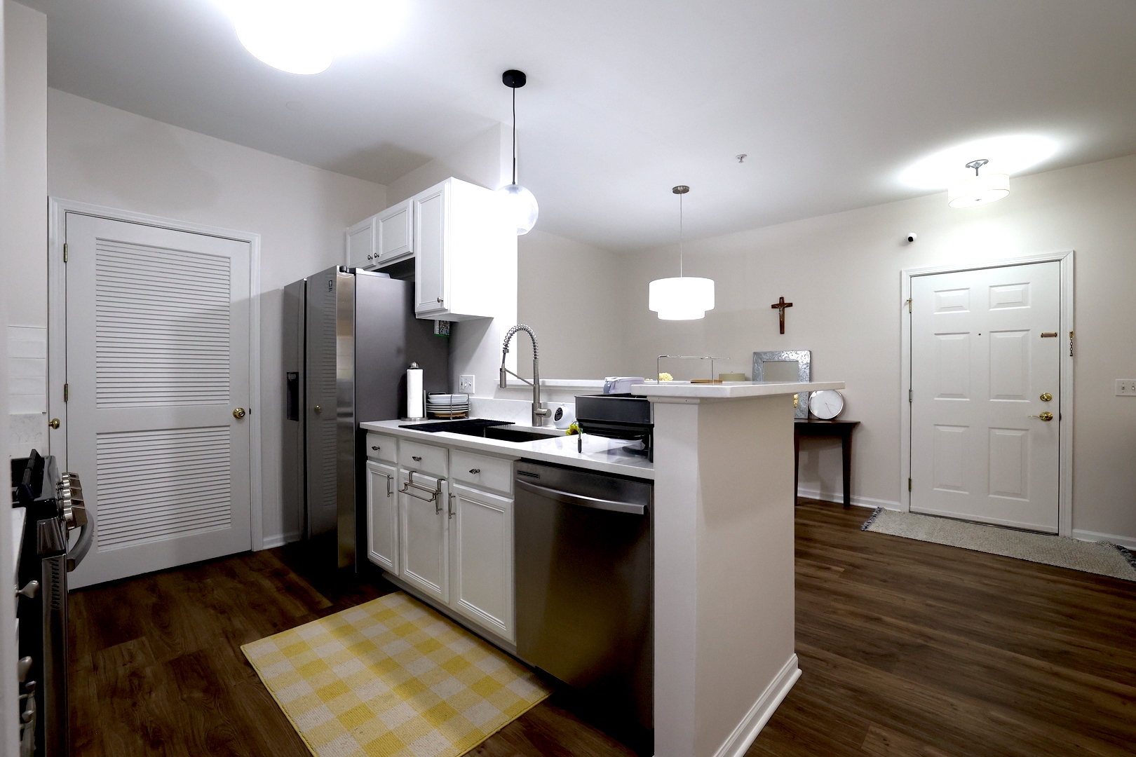 650 Mill Circle, Unit 103 Wheeling, IL 60090 - Photo 7 of 14 a kitchen with stainless steel appliances a refrigerator sink and wooden floor