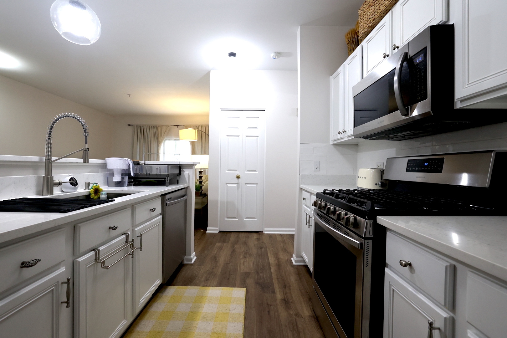 650 Mill Circle, Unit 103 Wheeling, IL 60090 - Photo 8 of 14 a kitchen with stainless steel appliances granite countertop a stove a sink and a microwave