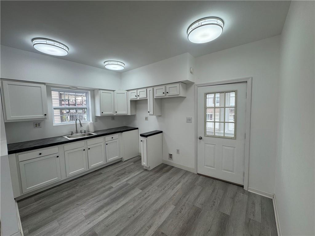 2212 Freeport Road Natrona Heights, PA 15065 - Photo 4 of 26 a large kitchen with a lot of cabinets and wooden floor