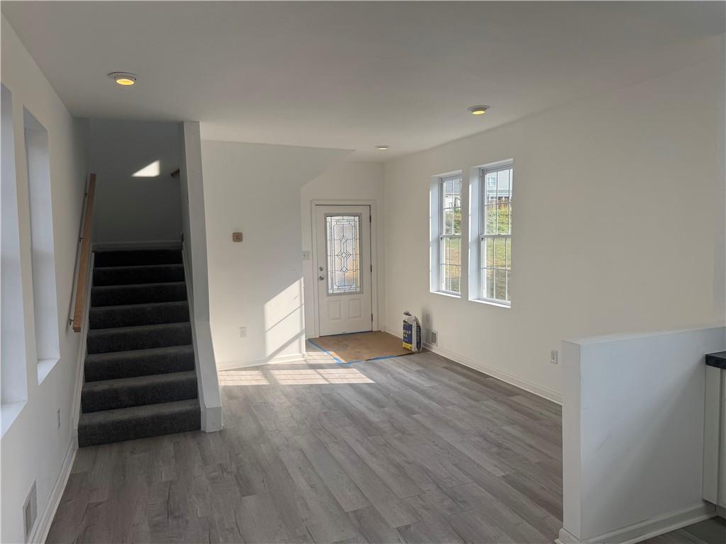 2212 Freeport Road Natrona Heights, PA 15065 - Photo 6 of 26 a view of an empty room with wooden floor and a window