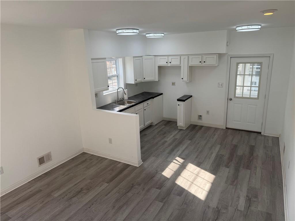 2212 Freeport Road Natrona Heights, PA 15065 - Photo 8 of 26 an empty room with wooden floor and windows