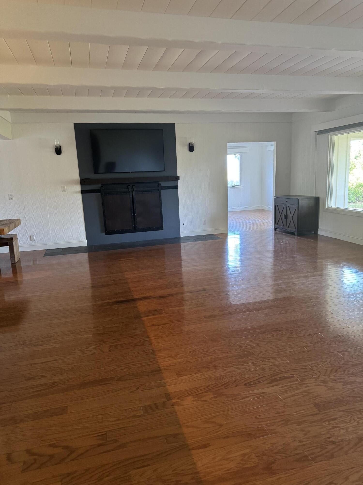 724 North Refugio Road Santa Ynez, CA 93460 - Photo 3 of 17 a view of empty room with wooden floor and fireplace