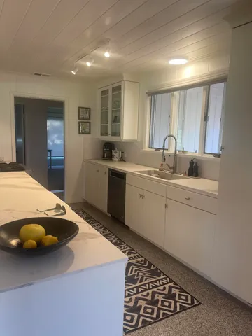 a kitchen with a sink a stove and cabinets