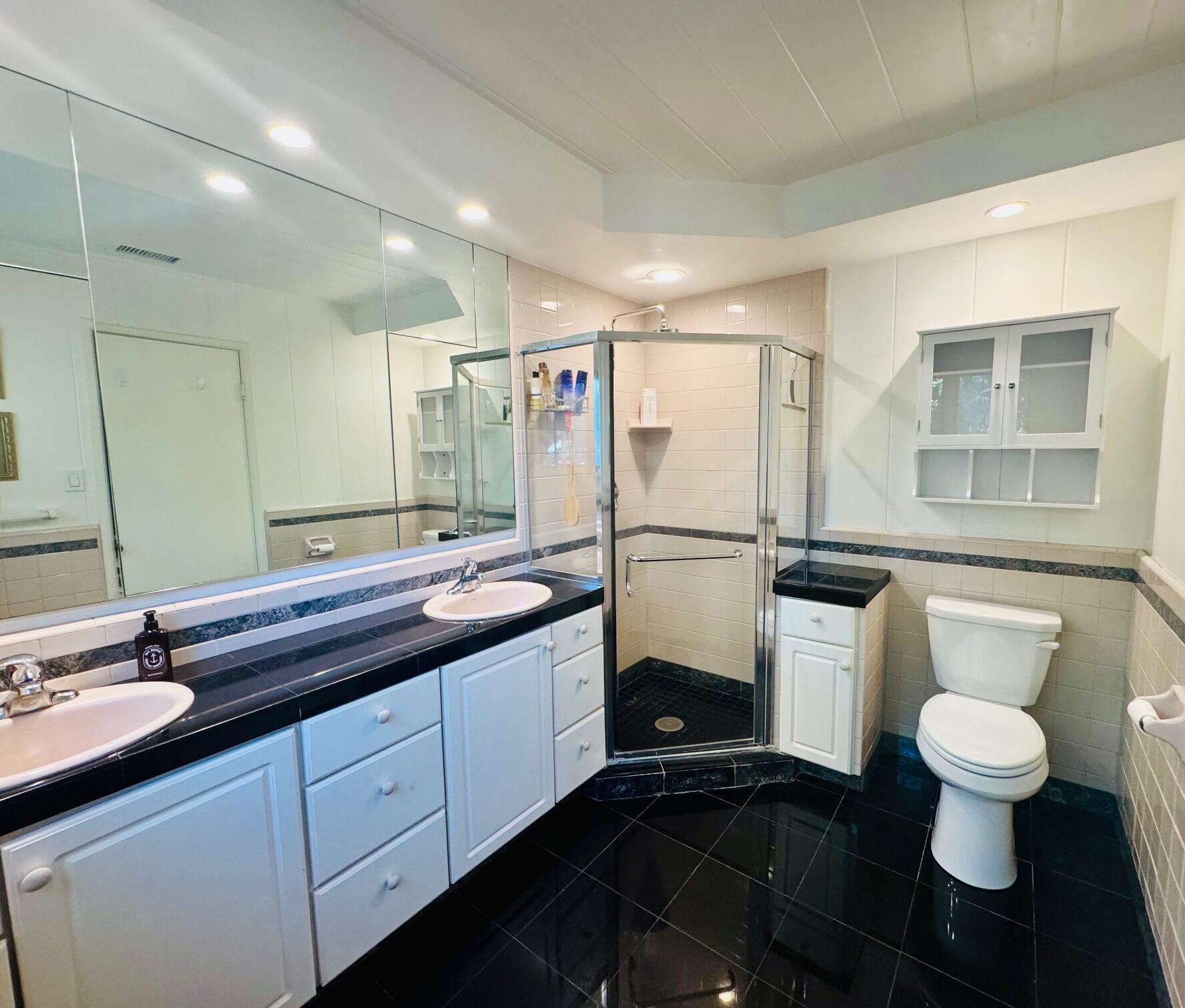 724 North Refugio Road Santa Ynez, CA 93460 - Photo 8 of 17 a spacious bathroom with a double vanity sink and a mirror