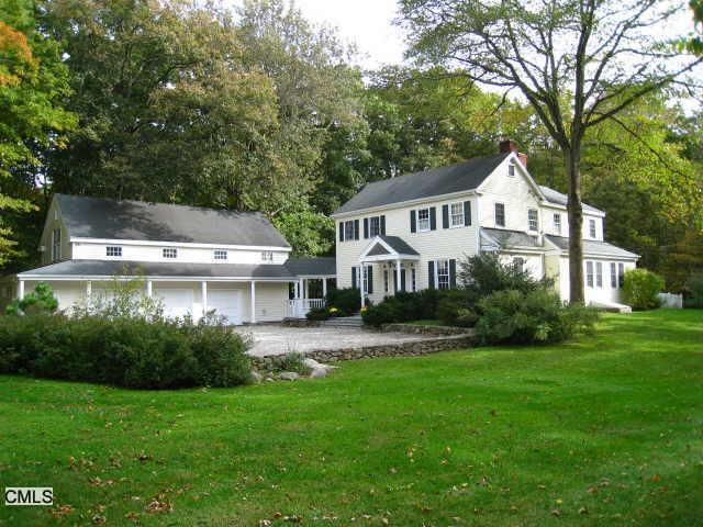 252 Belden Hill Road Wilton, CT 06897 - Photo 1 of 1 a front view of a house with a garden and trees