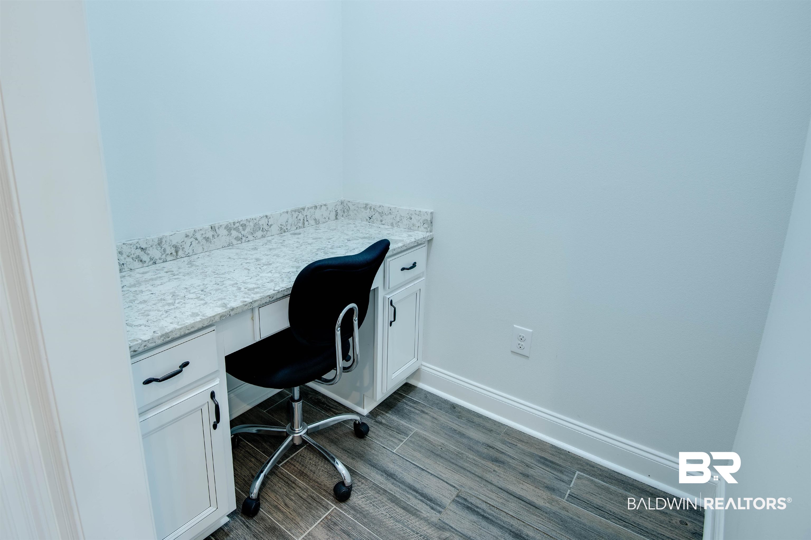 9843 Chipper Lane Foley, AL 36535 - Photo 12 of 34 Office area featuring built in desk, baseboards, and dark wood-style flooring