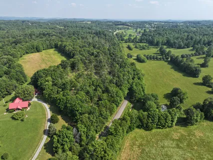an aerial view of a house with a yard and lake view