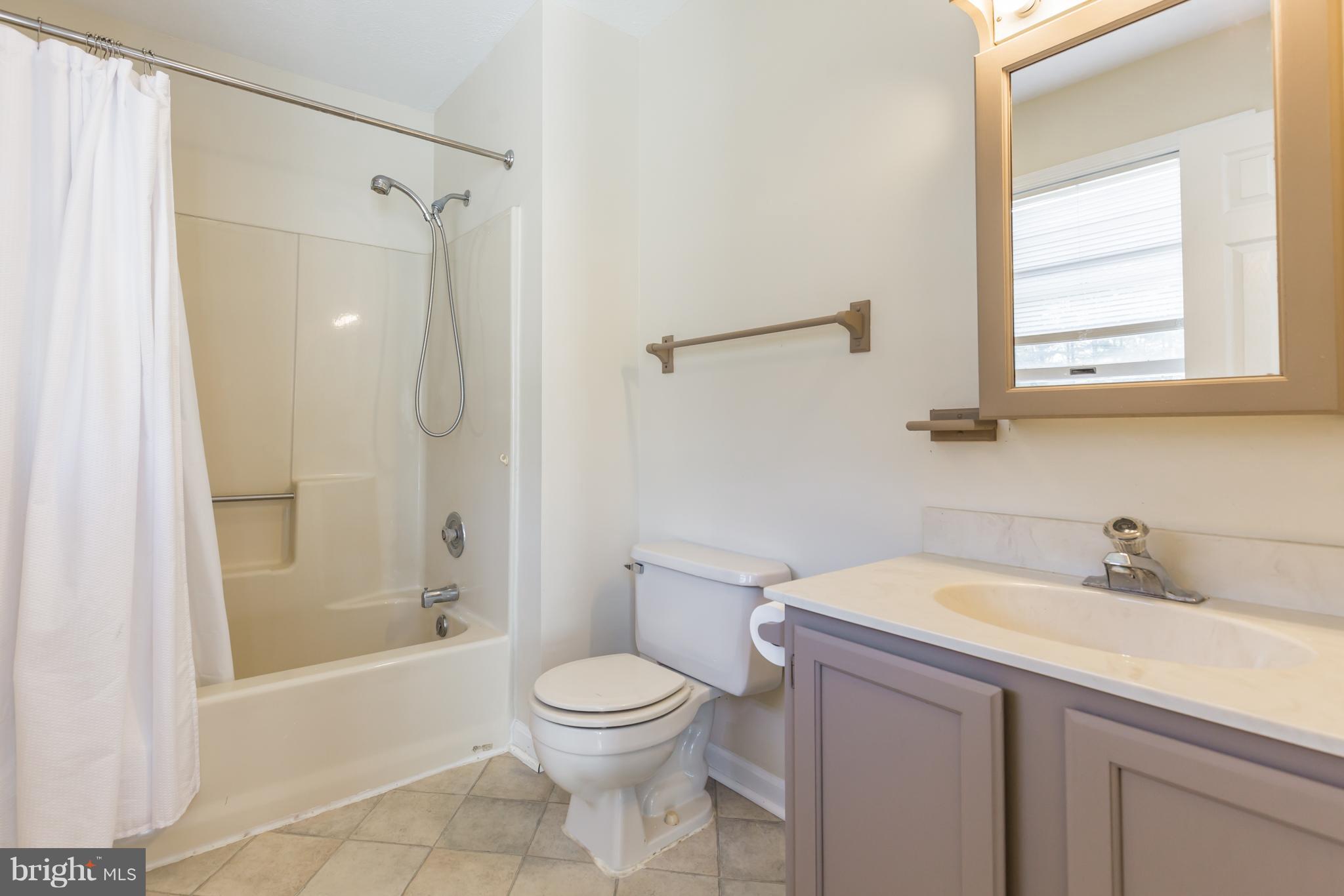 3142 Soper Road Huntingtown, MD 20639 - Photo 12 of 30 a bathroom with a sink a toilet and shower