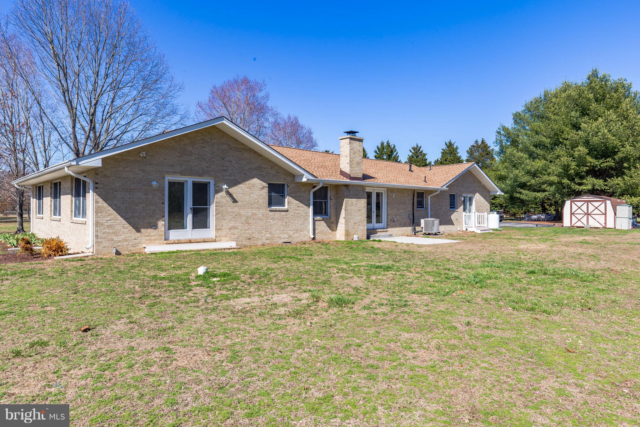 3142 Soper Road Huntingtown, MD 20639 - Photo 16 of 30 a front view of a house with a garden