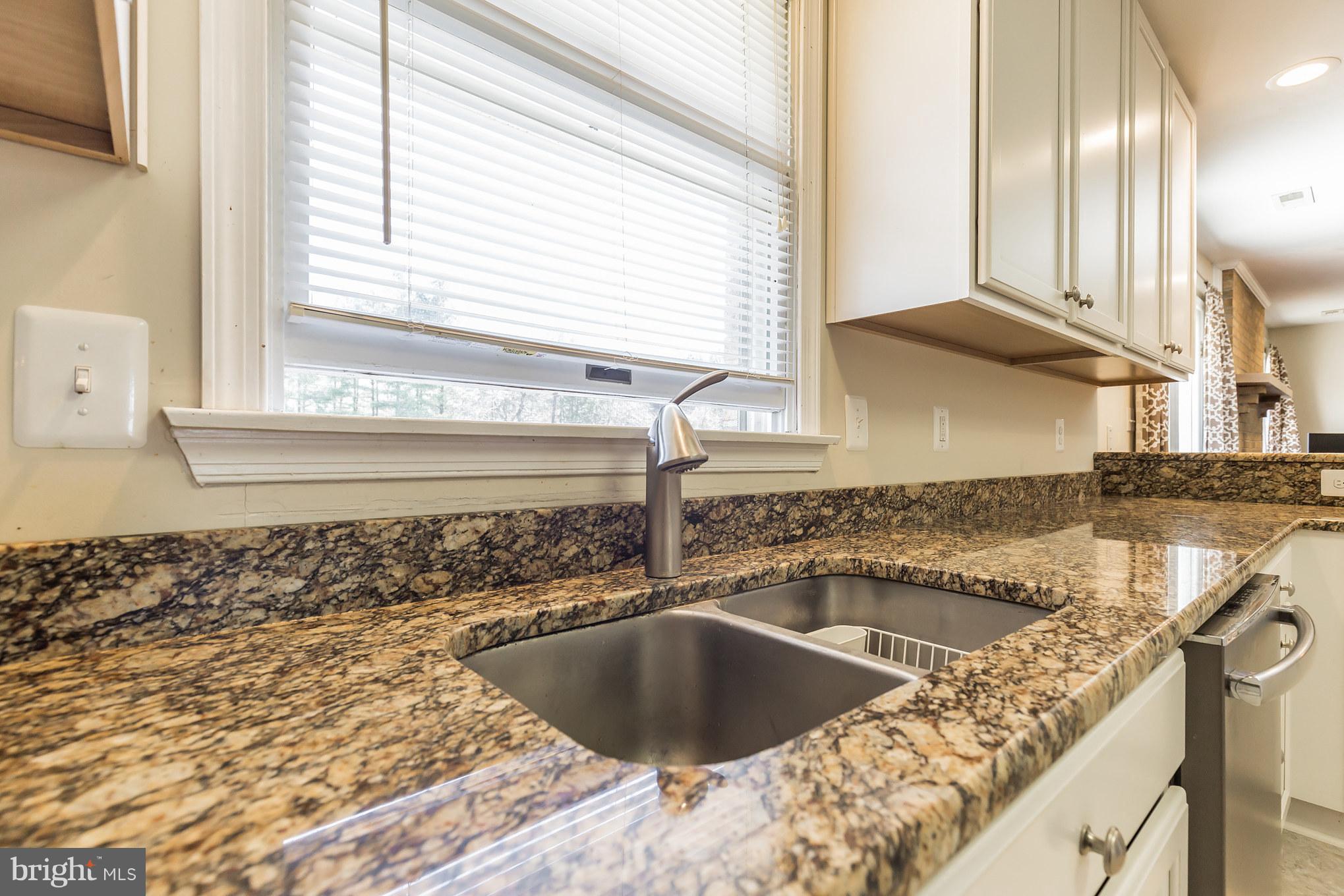 3142 Soper Road Huntingtown, MD 20639 - Photo 20 of 30 a kitchen with a sink granite counter tops and a window