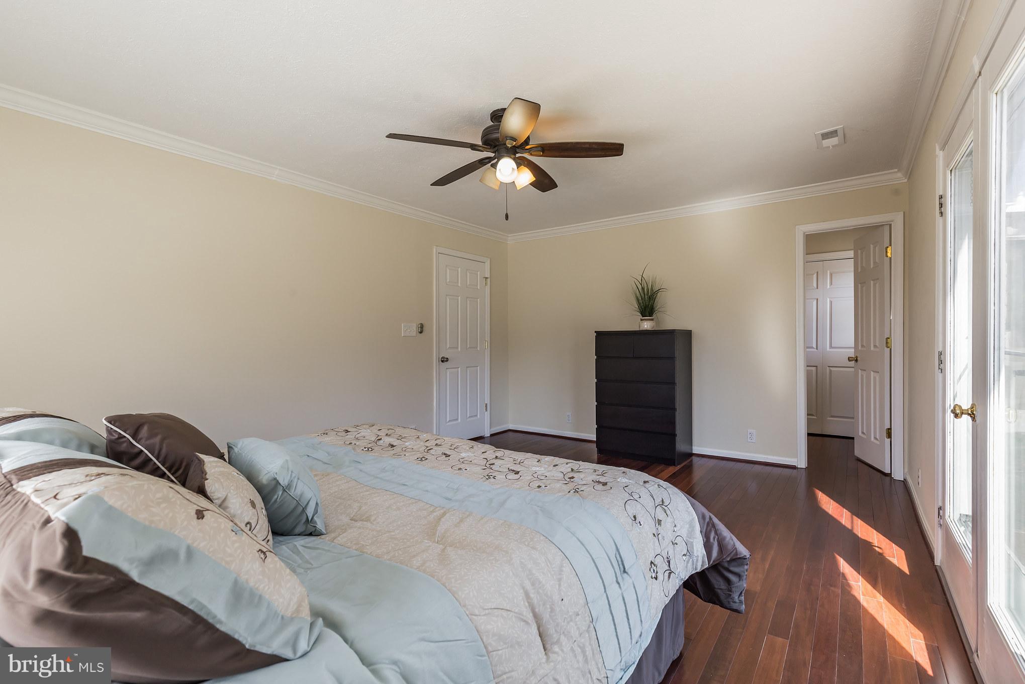 3142 Soper Road Huntingtown, MD 20639 - Photo 23 of 30 a bedroom with a bed and a chandelier