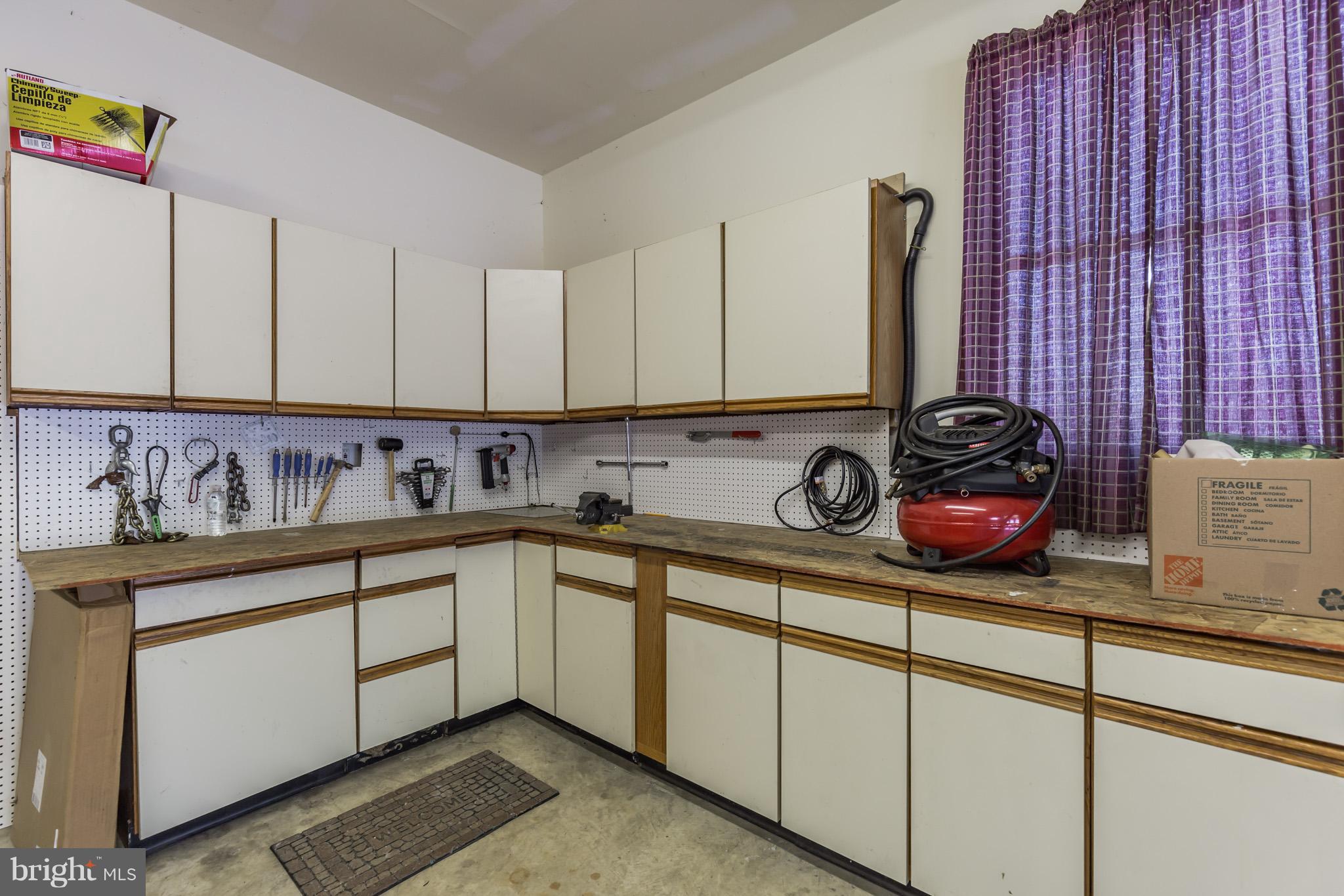 3142 Soper Road Huntingtown, MD 20639 - Photo 28 of 30 a kitchen with stainless steel appliances granite countertop a sink and a stove