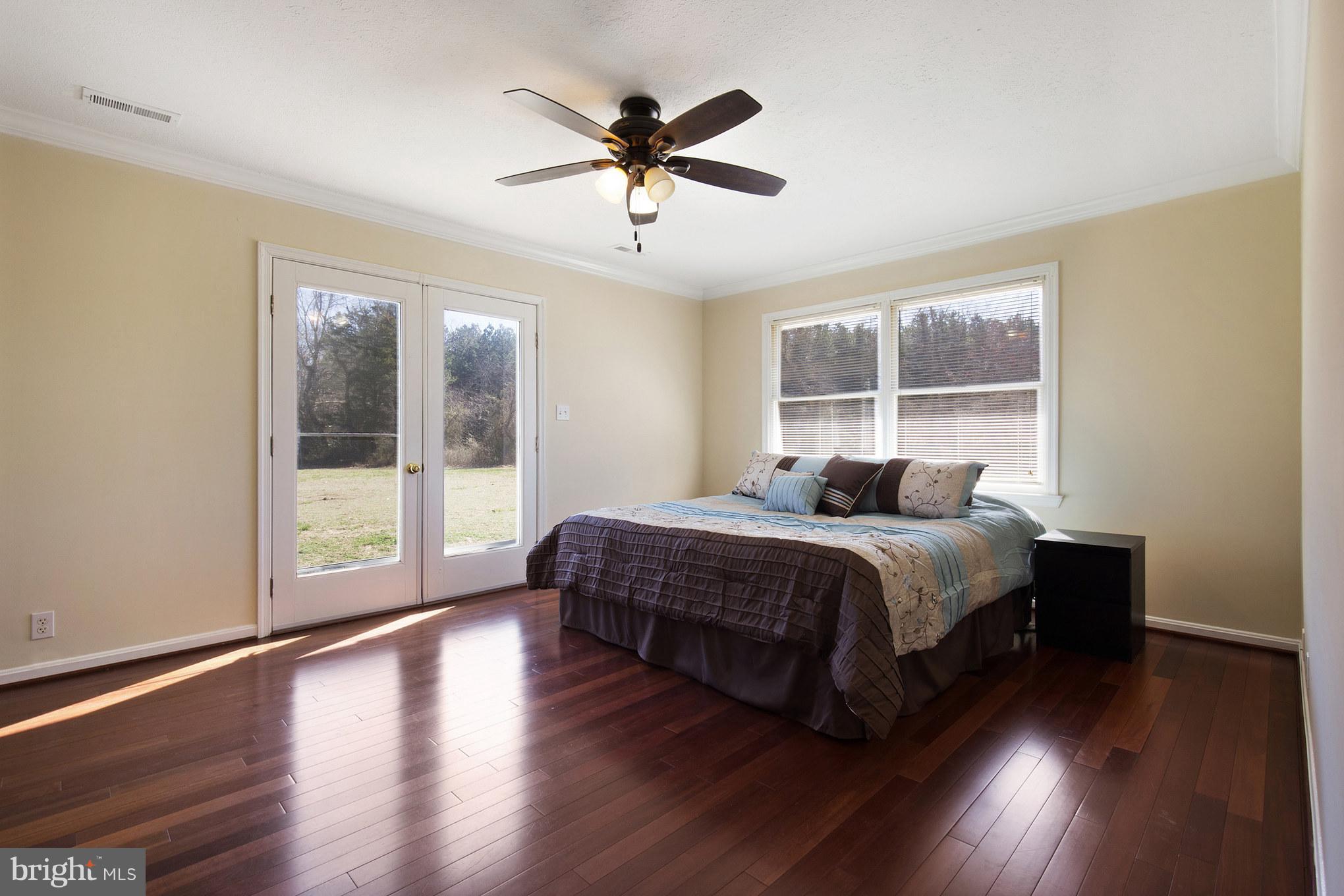 3142 Soper Road Huntingtown, MD 20639 - Photo 9 of 30 a bedroom with a large bed and a large window