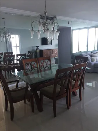 a view of a dining room with furniture and chandelier