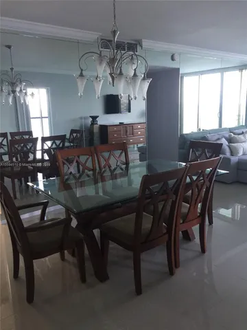 a view of a dining room with furniture and chandelier