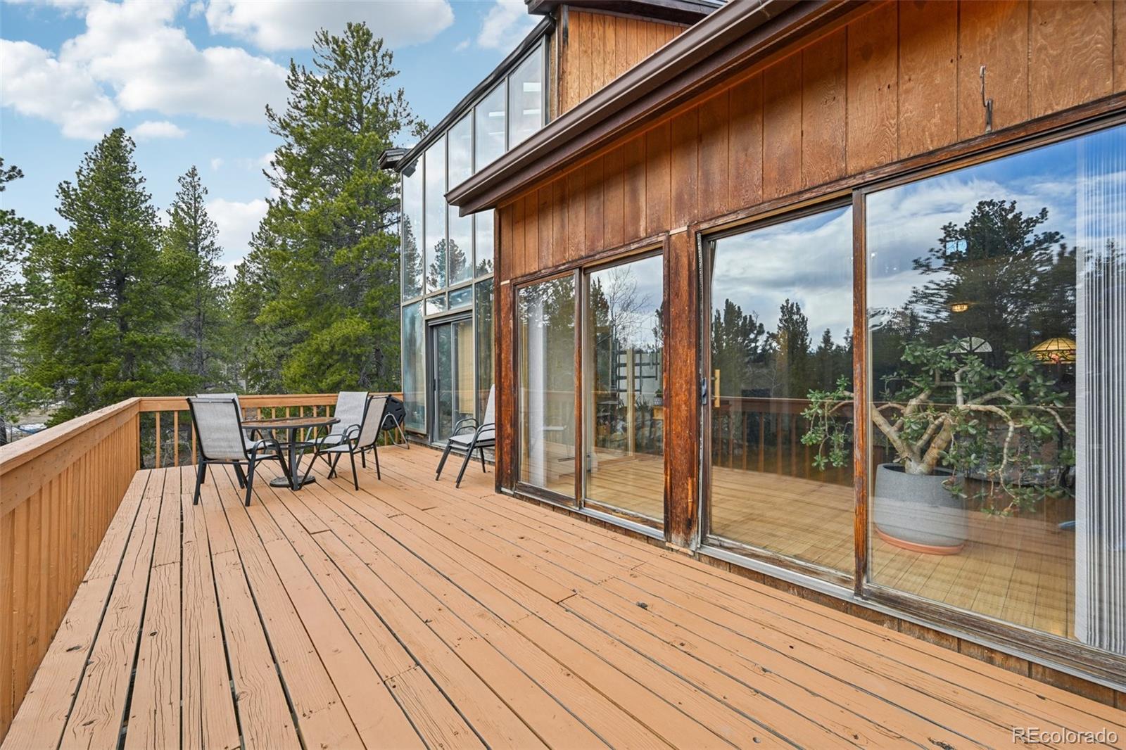 206 Pinon Circle Black Hawk, CO 80422 - Photo 21 of 50 a balcony with wooden floor and outdoor seating