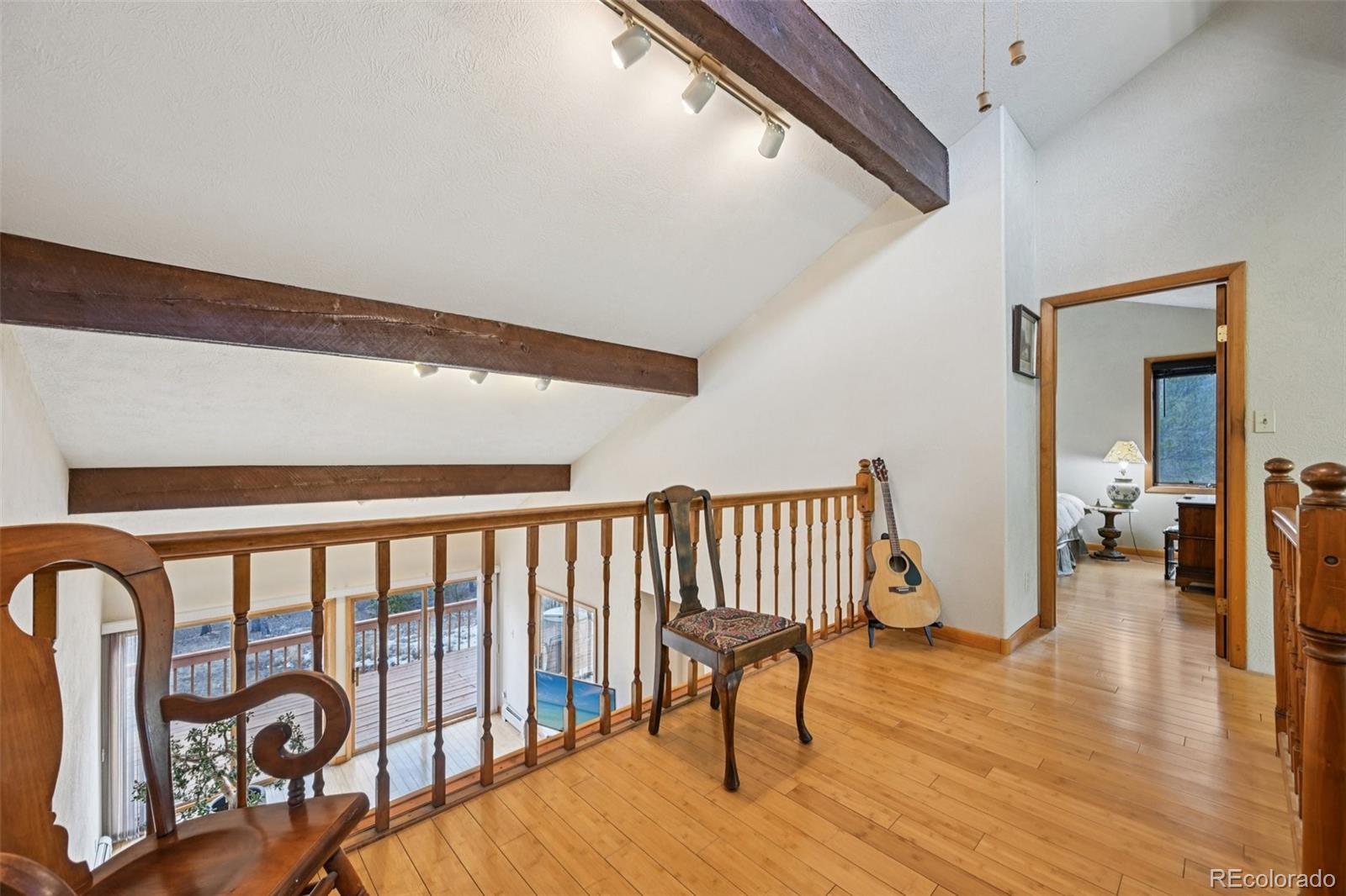 206 Pinon Circle Black Hawk, CO 80422 - Photo 24 of 50 a view of a hallway with wooden floor and fence