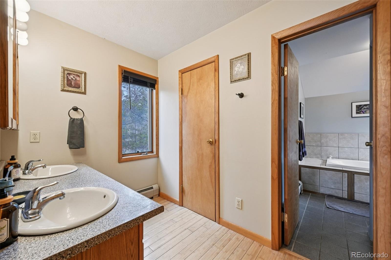 206 Pinon Circle Black Hawk, CO 80422 - Photo 28 of 50 a bathroom with a granite countertop sink and a mirror