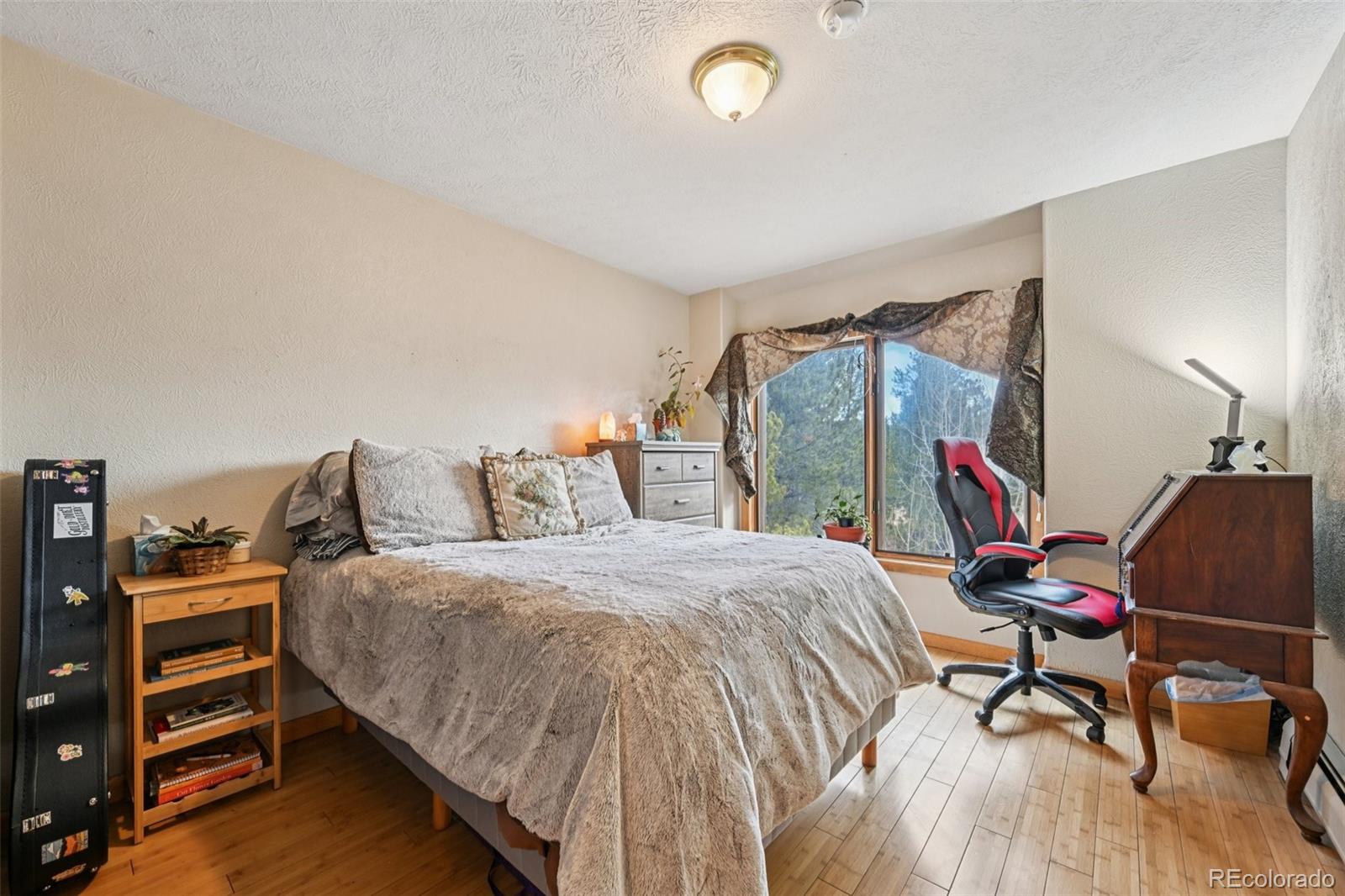 206 Pinon Circle Black Hawk, CO 80422 - Photo 29 of 50 a bedroom with a bed and a desk