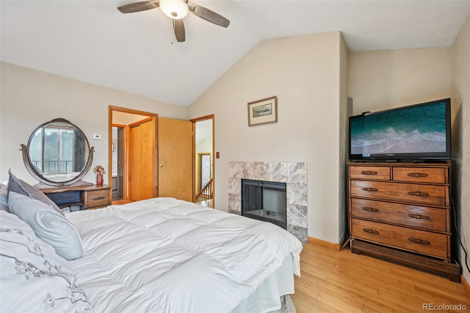 206 Pinon Circle Black Hawk, CO 80422 - Photo 30 of 50 a bedroom with a bed and a flat screen tv