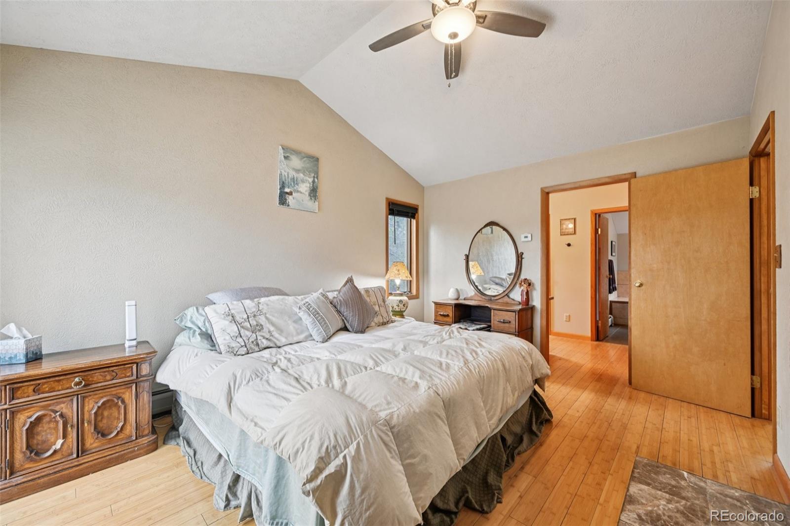 206 Pinon Circle Black Hawk, CO 80422 - Photo 31 of 50 a bed room with a bed mirror and a large window