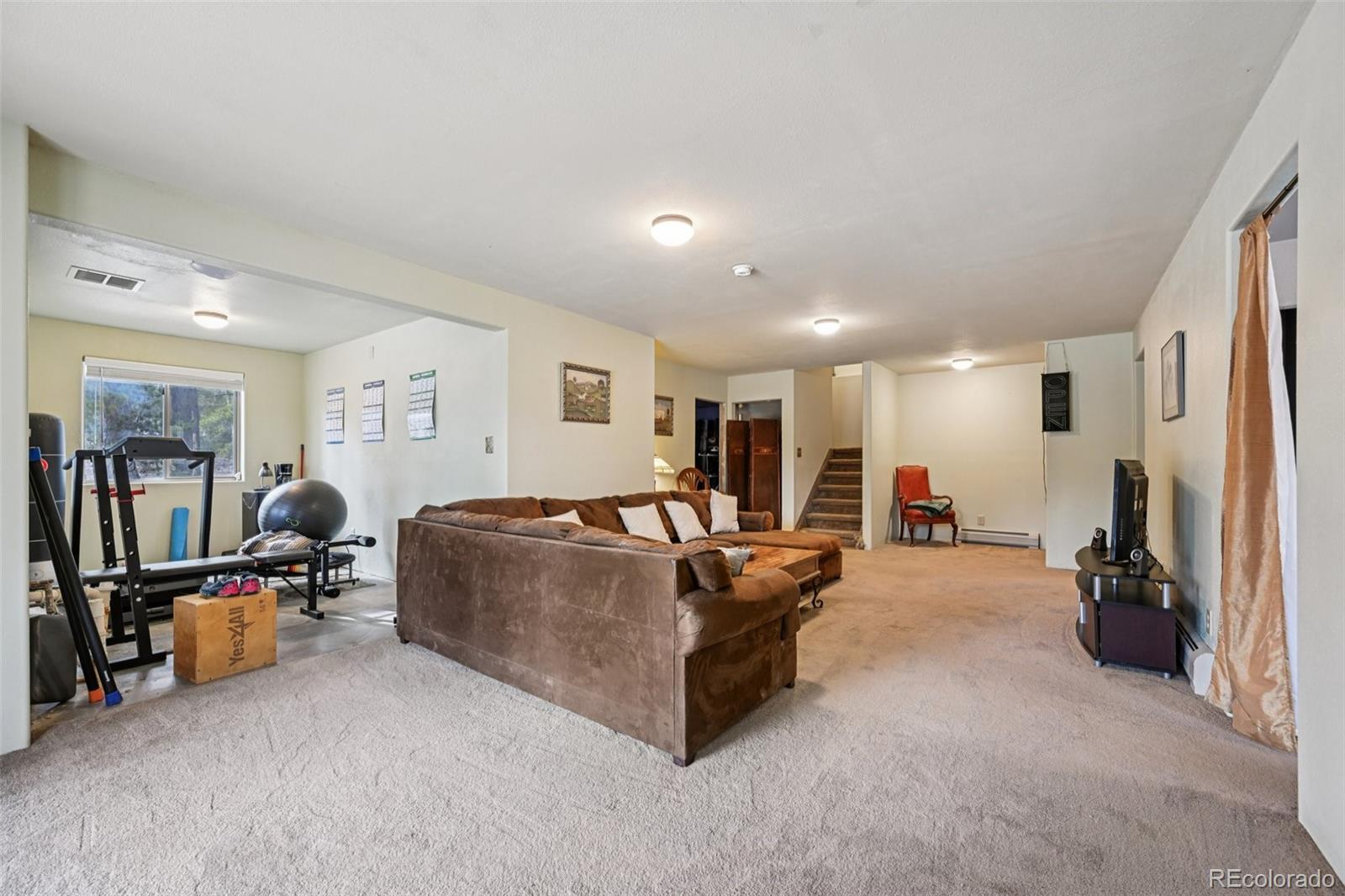 206 Pinon Circle Black Hawk, CO 80422 - Photo 38 of 50 a living room with furniture and a flat screen tv