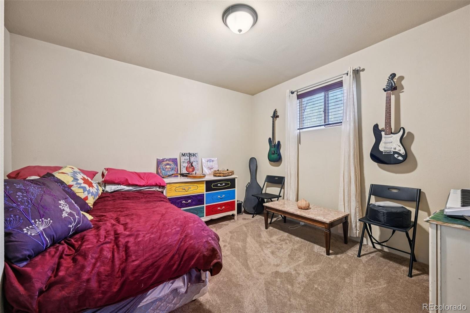 206 Pinon Circle Black Hawk, CO 80422 - Photo 40 of 50 a bedroom with a bed and a window