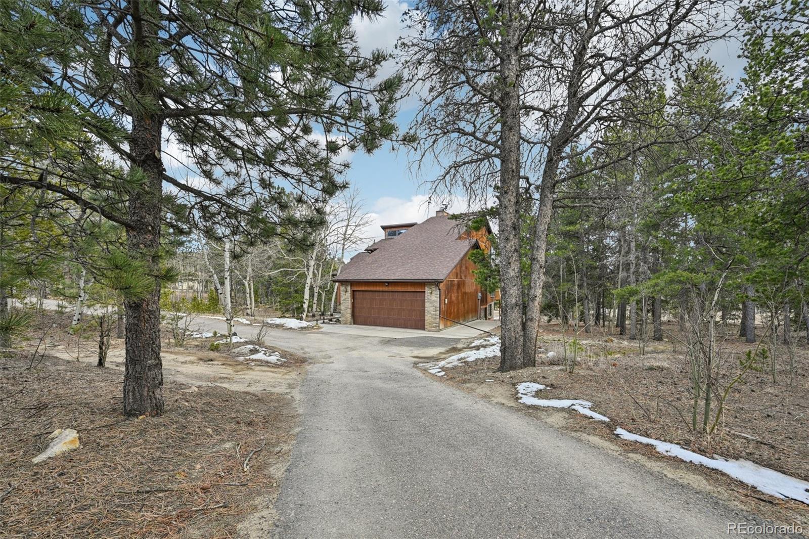 206 Pinon Circle Black Hawk, CO 80422 - Photo 4 of 50 a house with a tree in front of it