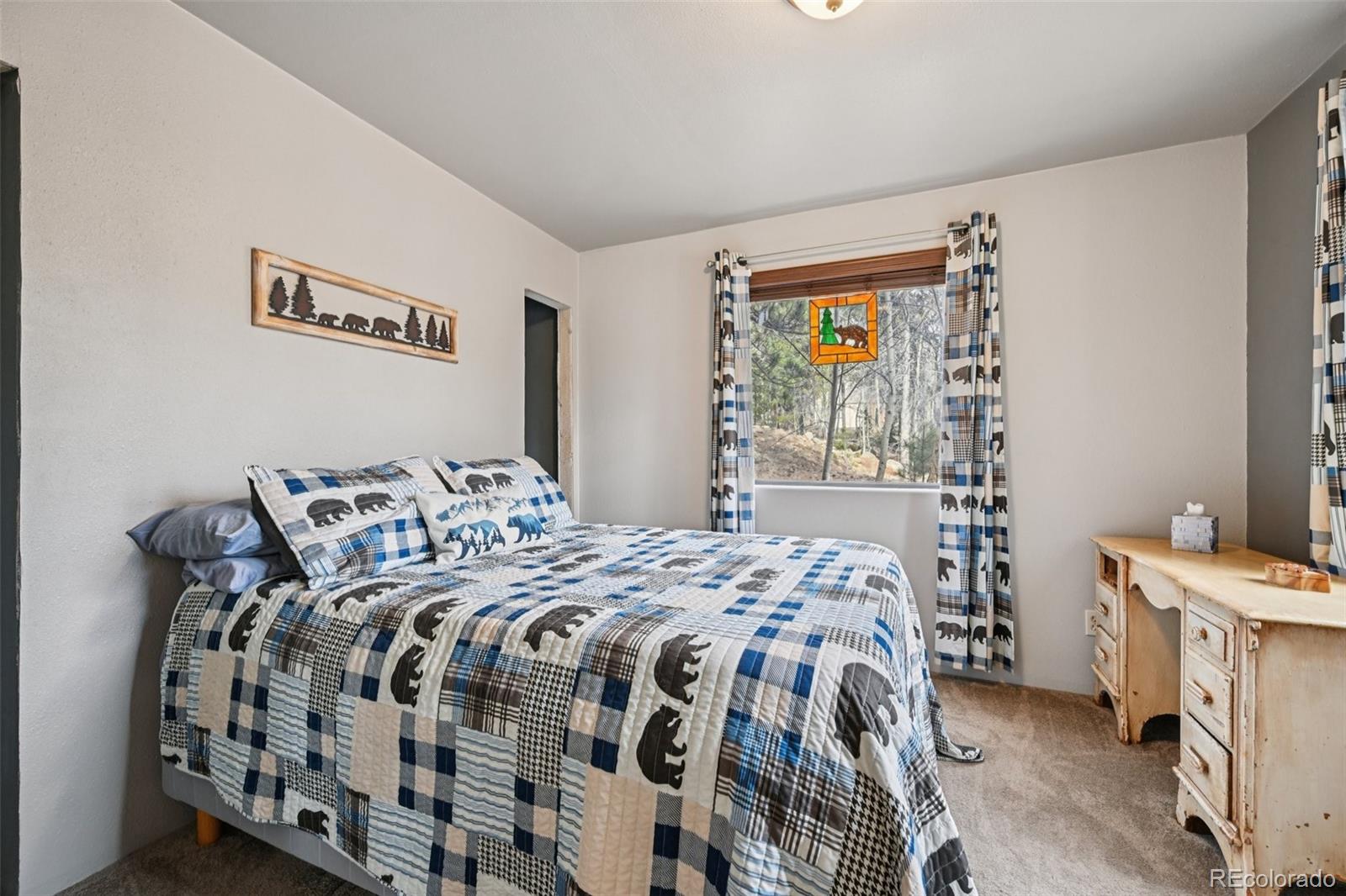 206 Pinon Circle Black Hawk, CO 80422 - Photo 41 of 50 a bedroom with a bed and a window