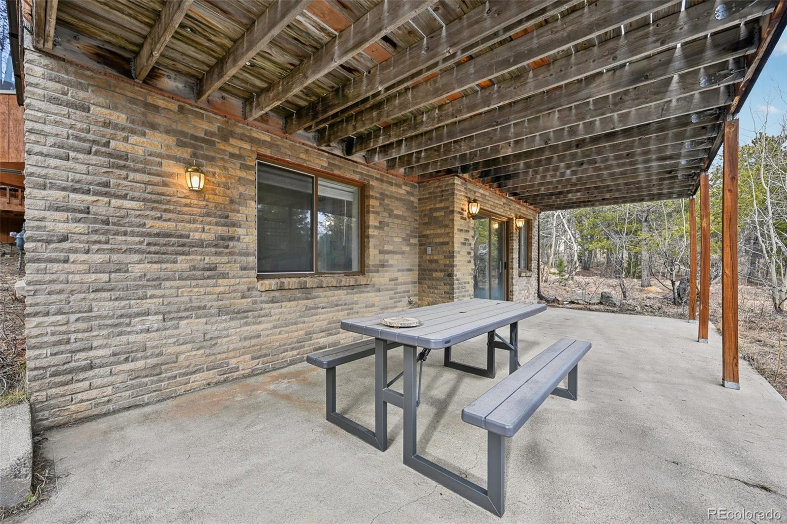 206 Pinon Circle Black Hawk, CO 80422 - Photo 42 of 50 a view of a porch with furniture and a yard
