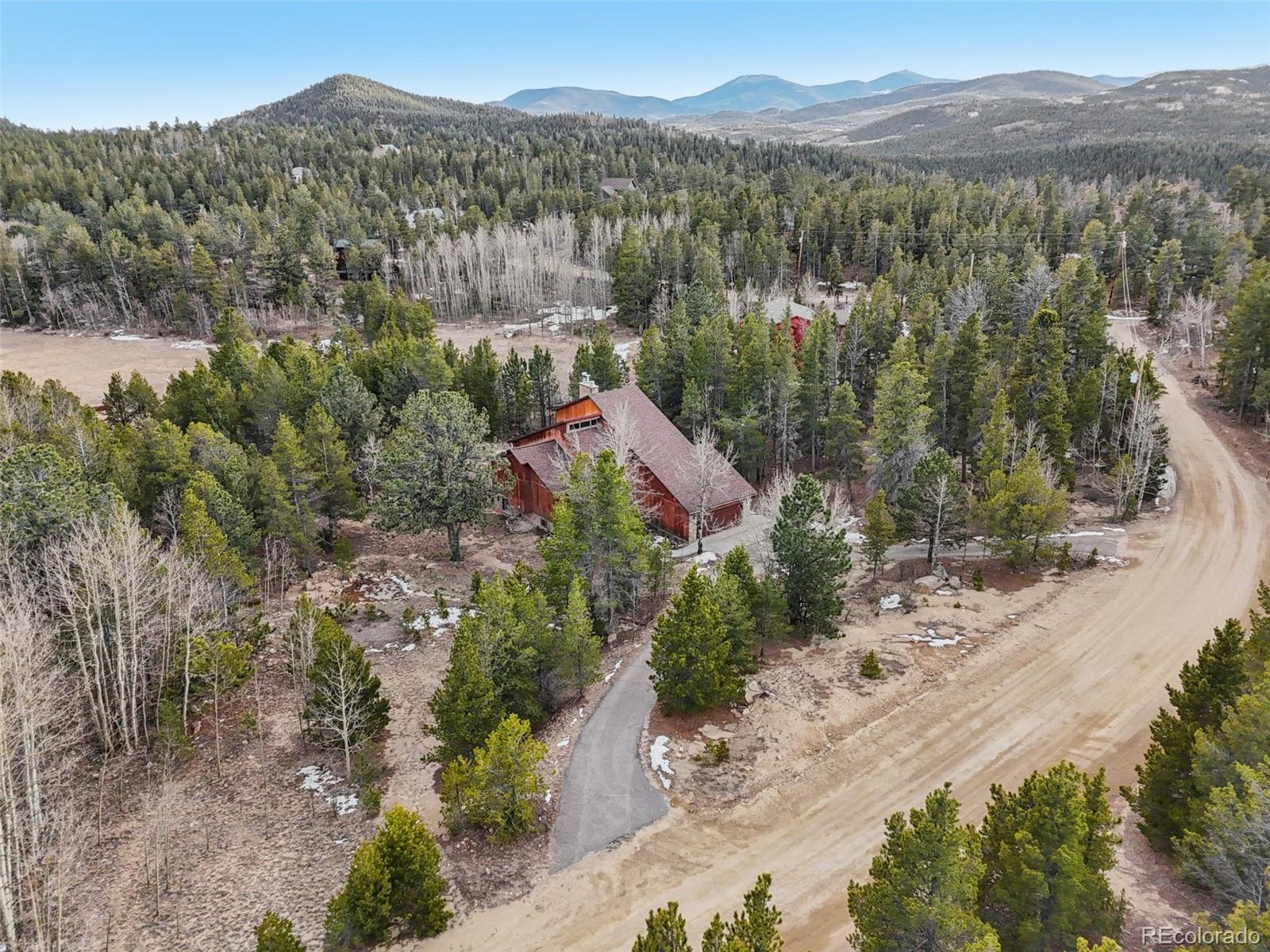 206 Pinon Circle Black Hawk, CO 80422 - Photo 44 of 50 an aerial view of green landscape with trees houses and mountain view