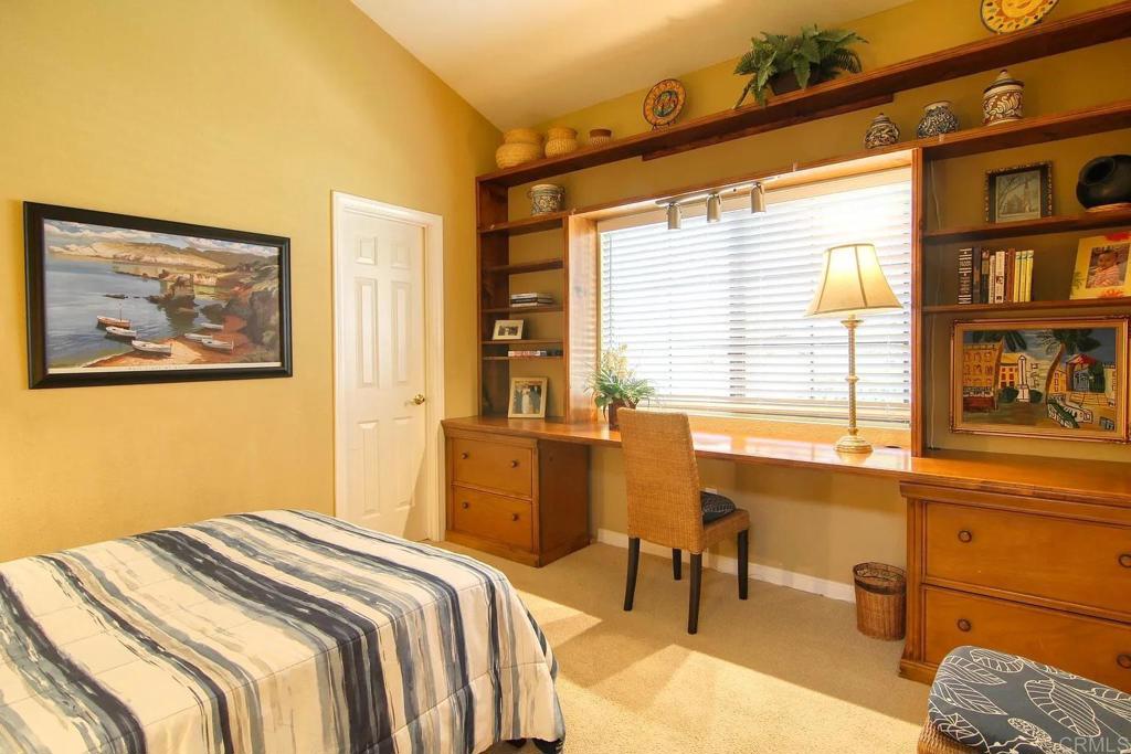 7302 Paseo Verde Carlsbad, CA 92009 - Photo 16 of 24 a bedroom with a bed and a window