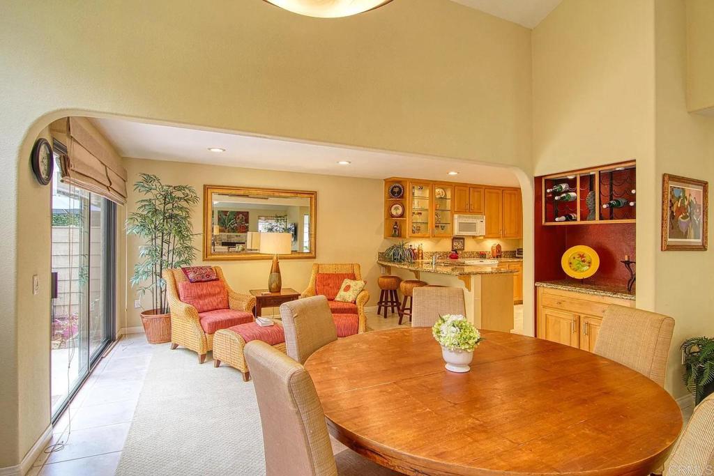 7302 Paseo Verde Carlsbad, CA 92009 - Photo 7 of 24 a living room with dining table and wooden floor